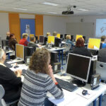 Erwachsene in einem Computerkursraum.